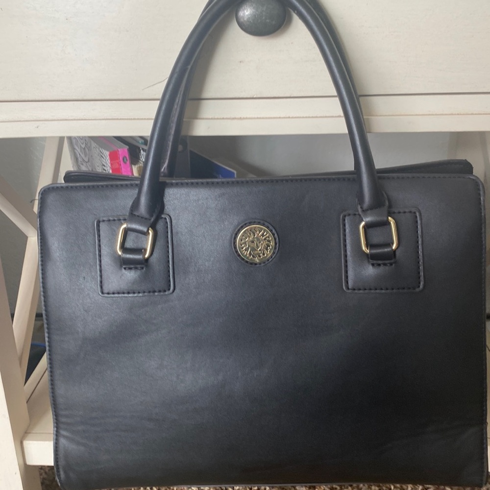 Anne Klein black purse with white pocka dots lined inside and gold logo purse.